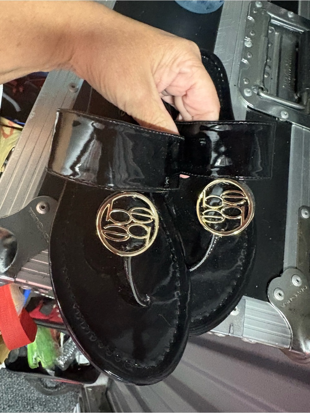 bebe Black Patent Toe-Post Sandals with Gold Emblem
